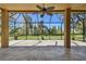 Large covered screened patio with tiled floor and ceiling fan offering outdoor living space at 7309 Night Heron Dr, Land O Lakes, FL 34637