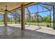 Covered and screened patio with tiled flooring and outdoor ceiling fan, ideal for entertaining at 7309 Night Heron Dr, Land O Lakes, FL 34637