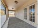 Expansive covered patio with double doors and views of the lush green backyard beyond at 7309 Night Heron Dr, Land O Lakes, FL 34637