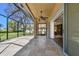 Beautiful screened patio with ceiling fan, tiled floor and sliding door access to the home's interior at 7309 Night Heron Dr, Land O Lakes, FL 34637
