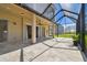 Expansive screened patio featuring a ceiling fan and outdoor lighting to entertain guests at 7309 Night Heron Dr, Land O Lakes, FL 34637