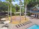 Community splash pad with seating and palm trees near the community pool at 7309 Night Heron Dr, Land O Lakes, FL 34637