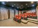 Enjoy movies in this theater room, featuring tiered seating and a projector at 7309 Night Heron Dr, Land O Lakes, FL 34637