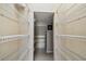 Bright walk-in closet featuring white wire shelving and neutral walls at 7309 Night Heron Dr, Land O Lakes, FL 34637