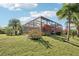 View of enclosed pool from a landscaped backyard with vibrant foliage at 8057 Rio Bella Pl, Bradenton, FL 34201