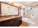 Bathroom showcases a dual sink vanity with granite countertops, a soaking tub, and a tiled glass shower at 8057 Rio Bella Pl, Bradenton, FL 34201