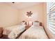 Bedroom with twin beds, palm tree decor and neutral-toned walls at 8057 Rio Bella Pl, Bradenton, FL 34201