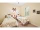 Bedroom with twin beds, palm tree decor and neutral-toned walls at 8057 Rio Bella Pl, Bradenton, FL 34201