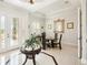 Bright dining area with decorative mirror, tiled floors and an ornate glass front entry door at 8057 Rio Bella Pl, Bradenton, FL 34201