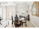 Bright dining area with tile floors, shuttered windows, and a decorative glass front door at 8057 Rio Bella Pl, Bradenton, FL 34201