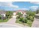 Well-maintained single story home featuring a terracotta-tiled roof and verdant landscaping at 8057 Rio Bella Pl, Bradenton, FL 34201