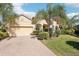 Inviting one-story home with a brick driveway, a two-car garage, and well-maintained front yard landscaping at 8057 Rio Bella Pl, Bradenton, FL 34201