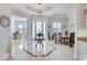 Bright foyer showcasing tile floors, tray ceilings, chandelier, and views of the living spaces at 8057 Rio Bella Pl, Bradenton, FL 34201