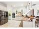 A chef's kitchen featuring stainless steel appliances, tile floors and a breakfast bar at 8057 Rio Bella Pl, Bradenton, FL 34201