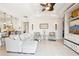 Comfortable living room with tile floors, a ceiling fan, and built-in shelving for storage at 8057 Rio Bella Pl, Bradenton, FL 34201