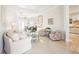 Inviting living room featuring tile flooring, neutral decor, and an open layout with views of the kitchen at 8057 Rio Bella Pl, Bradenton, FL 34201