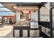 Outdoor kitchen with granite countertops, stainless steel grill, sink and storage at 8057 Rio Bella Pl, Bradenton, FL 34201