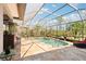 Enclosed pool area featuring a serene water feature, tile flooring, and comfortable lounge seating at 8057 Rio Bella Pl, Bradenton, FL 34201