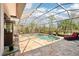 Enclosed pool area featuring a serene water feature, tile flooring, and comfortable lounge seating at 8057 Rio Bella Pl, Bradenton, FL 34201