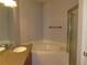 Bathroom featuring a garden tub and a glass shower at 829 Lantern Way # 829, Clearwater, FL 33765