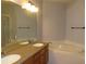 Bathroom featuring double sinks and a garden tub at 829 Lantern Way # 829, Clearwater, FL 33765