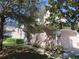 Two-story home featuring a two-car garage and lush green landscaping at 829 Lantern Way # 829, Clearwater, FL 33765