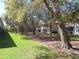 Exterior condo view with a lush lawn, mature trees, and a peaceful setting at 829 Lantern Way # 829, Clearwater, FL 33765