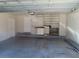 Attached garage with painted walls, storage cabinets, and shelving at 829 Lantern Way # 829, Clearwater, FL 33765