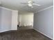 Spacious living room featuring neutral paint, carpet, and ceiling fan at 829 Lantern Way # 829, Clearwater, FL 33765
