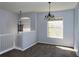 Bright living space with modern chandelier lighting and natural light through the large window at 829 Lantern Way # 829, Clearwater, FL 33765