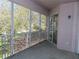 Covered porch area with screened windows overlooking the landscape with sliding glass door at 829 Lantern Way # 829, Clearwater, FL 33765