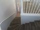 Carpeted staircase with white railings and stained glass front door visible at 829 Lantern Way # 829, Clearwater, FL 33765