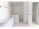 Contemporary bathroom with double vanity, white cabinets, and a walk-in shower featuring elegant tiling at 8917 Calumet Blvd, Port Charlotte, FL 33981