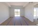 Bright bedroom with large windows and sliding glass door, prepped for flooring and paint to be completed at 8917 Calumet Blvd, Port Charlotte, FL 33981