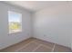 A bright bedroom features neutral walls and a window with a view at 8917 Calumet Blvd, Port Charlotte, FL 33981