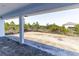 Covered patio providing an outdoor living space with a view of the surrounding undeveloped landscape at 8917 Calumet Blvd, Port Charlotte, FL 33981