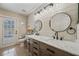 Elegant bathroom with double sinks, stone countertop, modern mirrors, and pool access at 9580 Grove Rd, Brooksville, FL 34613