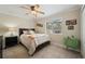 Well-lit bedroom with a large window, neutral tones, and stylish decor at 9580 Grove Rd, Brooksville, FL 34613