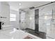 Modern bathroom showcasing a glass-enclosed shower with black and marble style tile and a unique sink and counter design at 9826 La Vonda St, Riverview, FL 33569