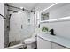 Modern bathroom boasts sleek glass shower with pebble accents, designer vanity, and contemporary black fixtures at 9826 La Vonda St, Riverview, FL 33569