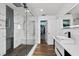 Contemporary bathroom featuring a glass shower with marble-like tiles, a modern sink, and a glimpse into the walk-in closet at 9826 La Vonda St, Riverview, FL 33569