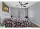 Cozy bedroom featuring neutral gray walls and a floral patterned comforter at 9826 La Vonda St, Riverview, FL 33569