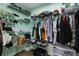 Organized walk-in closet with ample shelving, hanging space, and neat storage solutions for shoes and clothing at 9826 La Vonda St, Riverview, FL 33569