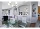 Dining room with chandelier, six chairs, glass table, tile floors, open concept, and grey paint at 9826 La Vonda St, Riverview, FL 33569