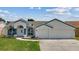 Beautiful single-story home with a two-car garage, featuring a well-kept lawn and pleasing curb appeal at 9826 La Vonda St, Riverview, FL 33569
