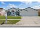 Charming single-story home with a well-maintained lawn and a two-car garage in a residential neighborhood at 9826 La Vonda St, Riverview, FL 33569