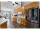 Kitchen boasts stainless steel appliances, wood cabinetry, and wood-look flooring at 9826 La Vonda St, Riverview, FL 33569