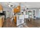 Open concept kitchen featuring tile floors, a breakfast bar with seating, and views of the living area at 9826 La Vonda St, Riverview, FL 33569