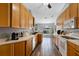 Well-lit kitchen featuring lots of wood cabinetry, and wood-look flooring at 9826 La Vonda St, Riverview, FL 33569