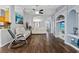 Open concept living area with tile floors, white couches, decorative columns, and a built-in entertainment center at 9826 La Vonda St, Riverview, FL 33569